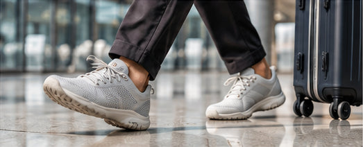 Light casual shoes beside a travel suitcase